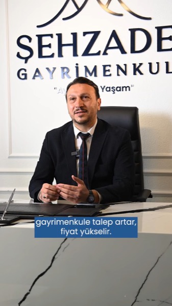 Danışmanımız ofiste, Şehzade Gayrimenkul panosunun önünde